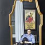Adam Gebhardt sits reflected on an Eames lounge chair in his favorite room, the den, with his King Charles Cavalier/Poodle mix, Truman. Behind him is a poster he bought when he was age 17 from a street vendor in Madrid who had asked him his name. Not understanding why, Adam replied with his Spanish name, Alfonso, which was then inserted in the text. “In retrospect, I’m glad. It looks better that way,” he said.